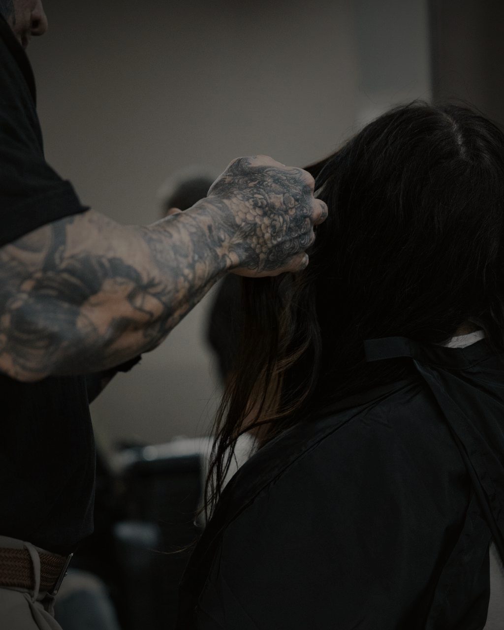 Detail of hands working through hair