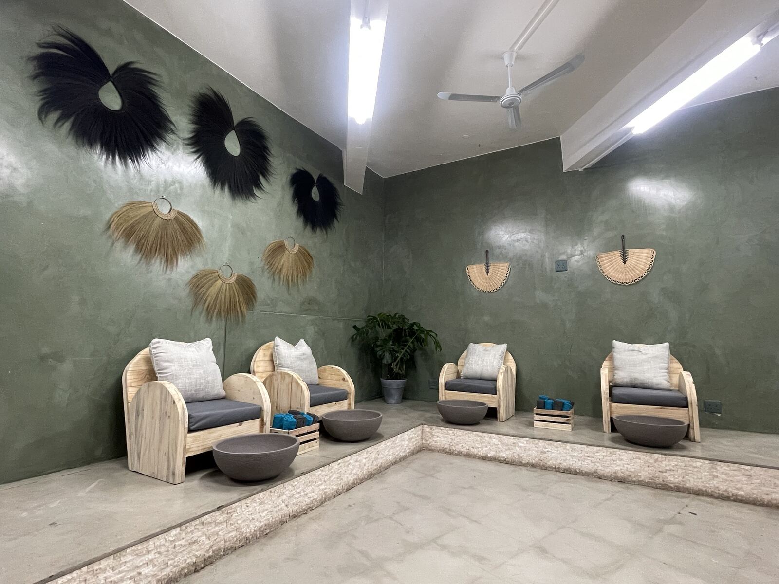 Pedicure lounge with feather wall art